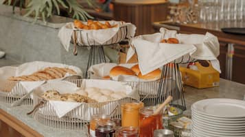 A buffet setup with various food items and condiments.