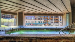 A hot tub area with a view of a multi-story building in the background.