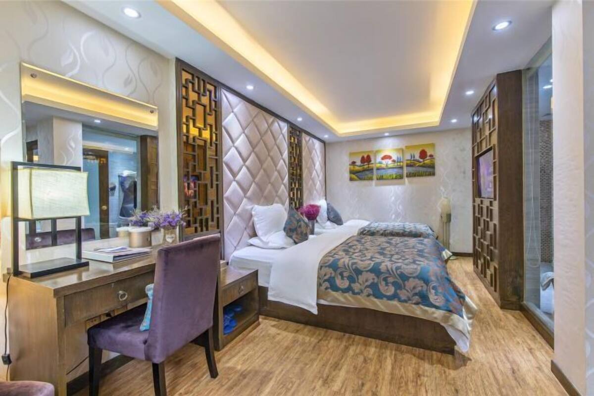 A modern bedroom with a bed, a desk, and a chair.