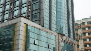 A modern building with a glass facade and the name "Kohinoor" prominently displayed. - Fu Gang Hotel (Guangzhou)