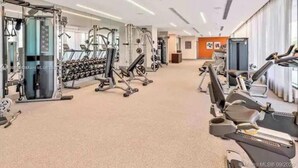 A spacious gym with various exercise machines, including treadmills and weightlifting equipment. - A705A Awesome DT Doral Apart
 (Doral)