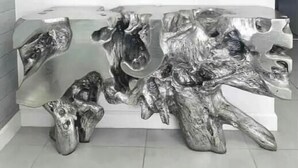 A modern interior with a unique wooden sculpture centerpiece, a white wall, and three metallic wall decorations. - A705A Awesome DT Doral Apart
 (Doral)