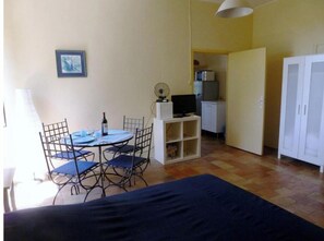 Cozy living space with a dining area, TV, and comfortable seating for four.