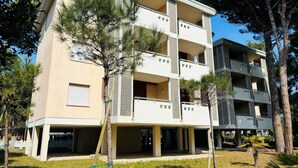 A multi-story residential building with balconies and a covered entrance area.