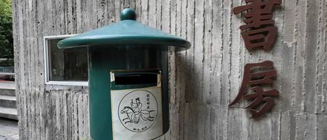 A traditional Chinese building with a signboard and a green lantern.