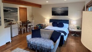 A bedroom with a bed, bedside tables, a chair, a desk, and a painting on the wall. - A Seaside Jacuzzi Escape in Parksville, British Columbia, Canada (Parksville)