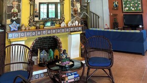 A cozy living room with a stone fireplace, a television, and comfortable seating. - Casa de Campo (El Valle de Antón)