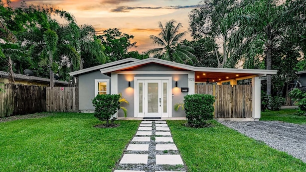 A single-story house with a front porch, a paved walkway leading to the entrance, and a number '1025' on the door. - Zen Retreat - Sauna, Pool, Cold Plunge & More! (Fort Lauderdale)