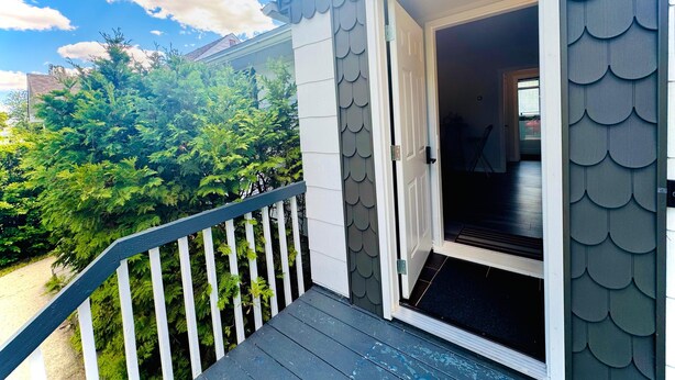 A house with a door open to a dark interior, surrounded by lush greenery. - Beautiful house//self check in//7 mins to YEG Airport//Nature walk🌴 (Leduc)