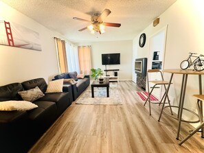 Relax in this stylish living room with a comfortable sofa, coffee table, and flat-screen TV.
