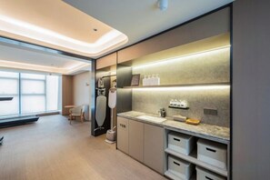 A modern kitchen with a built-in oven, a sink, and a countertop with storage drawers. - JI Hotel (Zhengzhou East Railway Station) (Zhengzhou)