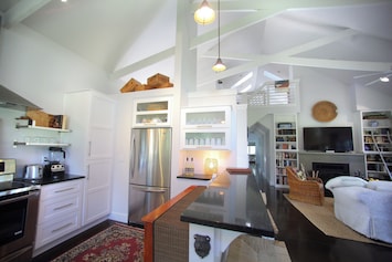 Open concept kitchen, unique architecture, and cozy furnishings