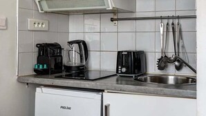 A compact kitchenette with a microwave, coffee maker, toaster, and a mini fridge. - 395 Suite BIOT 10 - Superb apartment in Paris (Paris 17 Batignolles-Monceau)