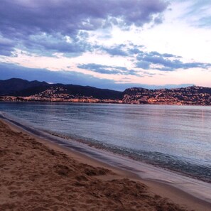A beach with a sandy shore and a calm sea.