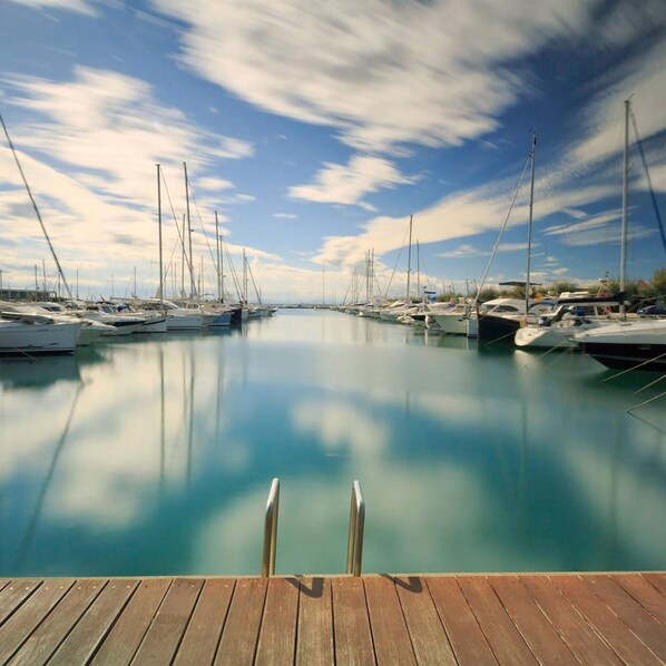 Guests can enjoy serene views of sailboats and calm waters from the marina.