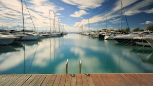 A marina with boats docked, calm water, and a wooden dock in the foreground. - Avenida 5B in Roses With 4 Bedrooms and 3 Bathrooms (Roses)