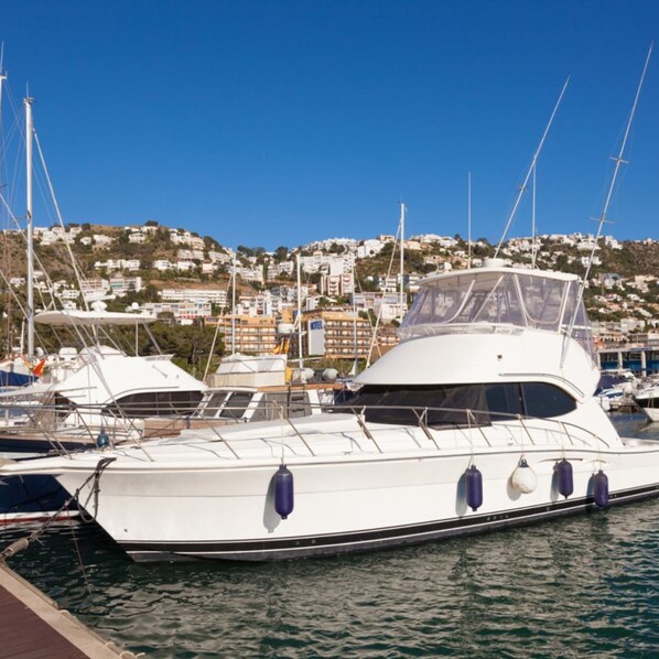 A marina with a white yacht docked.