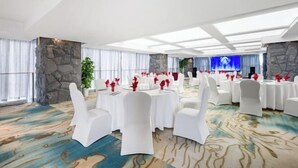 A banquet hall with round tables, white chairs, and a stone accent wall. - Tianping Hotel Shanghai Xujiahui（Wukang Road） (Shanghai)