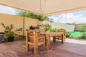 Enjoy al fresco dining on the patio, where a barbecue grill and comfortable seating await.