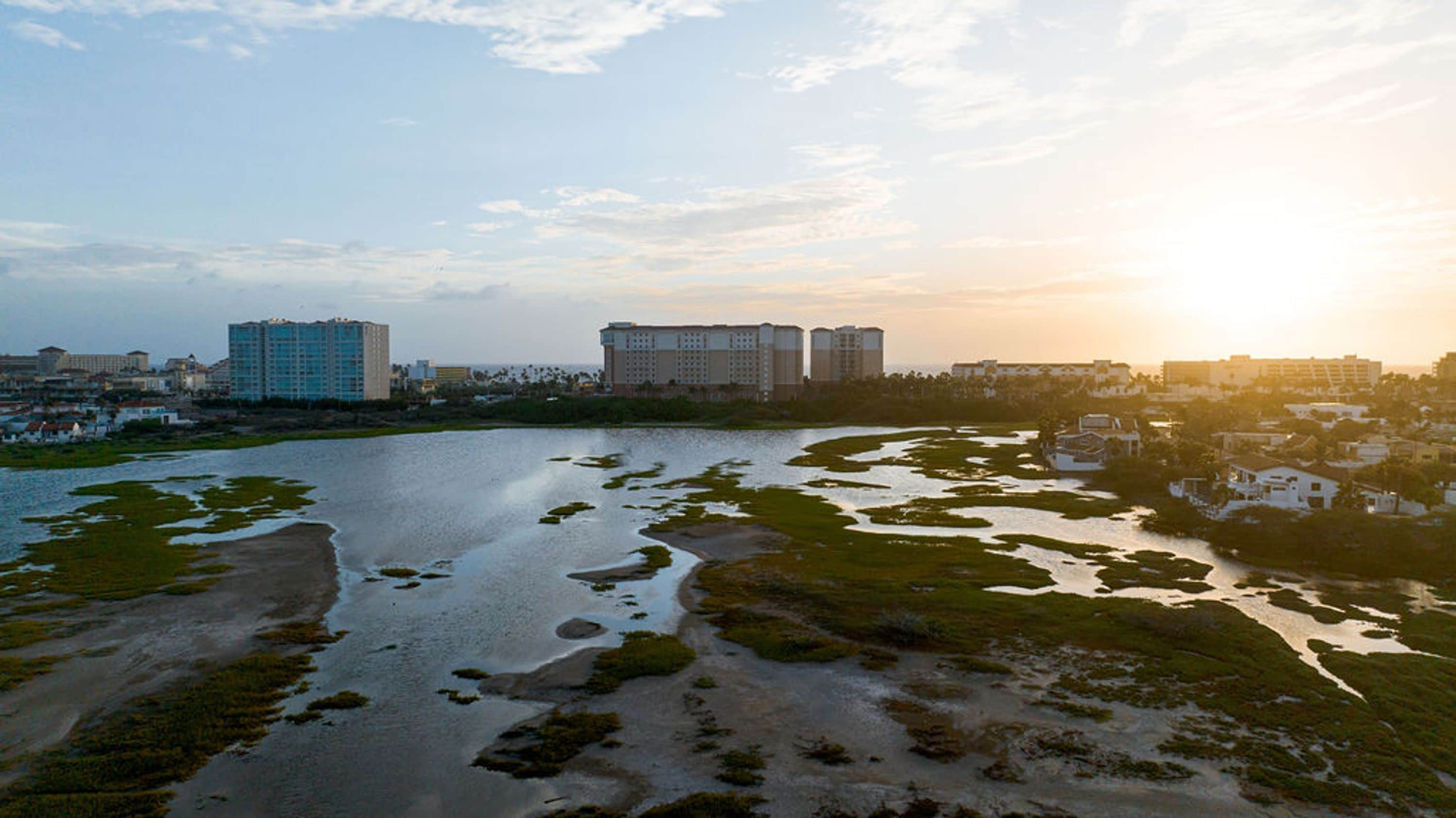 A coastal area with buildings and a body of water.