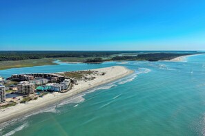 An aerial view of a coastal area with buildings along the shoreline, a beach, and a river or bay. - Stunning Location + Views • Oceanfront 2BR-1st Floor • Cherry Grove • Ocean View Villas B1 (North Myrtle Beach)