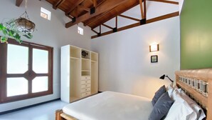 A bedroom with a bed, wardrobe, and a window with a view. - Hacienda siete sentidos  (La Mesa)