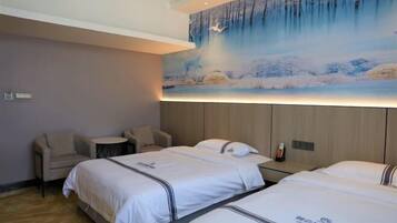 A hotel room with two beds, a small round table, and a chair.