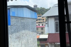 A view of a residential area with multi-story buildings, some with visible balconies and windows. - Nandan Home Inn Paibaiyun Hotel (Nandan)