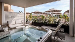 A rooftop terrace with a hot tub, lounge chairs, and umbrellas. - Terradamari Resort & Spa Marina di Modica, Tapestry by Hilton (Modica)