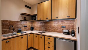 A kitchen with wooden cabinets, a stone backsplash, a stainless steel sink, and a built-in oven.