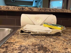 A kitchen counter with a rolled-up towel and a package of dish soap. - Pool, Hot Tub & Gym | Near Fernie Alpine Resort (Fernie)