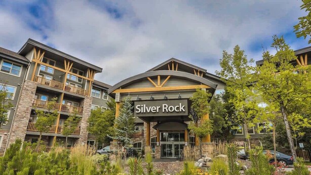 A multi-story hotel with a prominent "Silver Rock" sign, featuring balconies and a stone facade. - Pool, Hot Tub & Gym | Near Fernie Alpine Resort (Fernie)