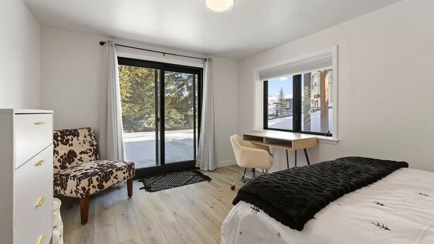 A modern bedroom with a bed, a desk, a chair, and a wardrobe. - 10min Beaver Creek | 15 min Vail (Avon)