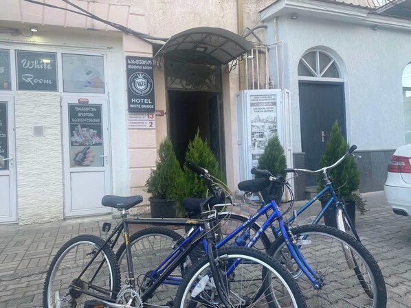 A hotel entrance with a sign indicating it is the White Bridge Hotel. There are two bicycles parked in front.