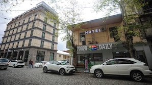 A hotel with a sign reading "HOTEL" and a building with a sign that says "DAILY". - Hotel WB (Kutaisi)