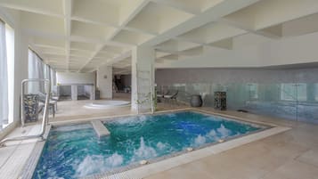 Relax by the rectangular pool surrounded by a white tiled deck and seating areas.