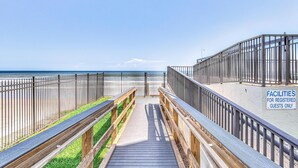 A wooden boardwalk leading to beach facilities for registered guests. - Ocean Trillium 803 - a 1 bedroom condo with beautiful ocean views (New Smyrna Beach)