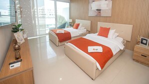 A hotel room with two beds, a TV, a desk, and a view of the city. - U-GO Edificio Morros Ultra (Cartagena)