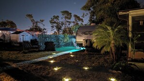 A backyard with a water feature, a grill, and a palm tree. - RV/camper in terrific Via Madonna property (Englewood)