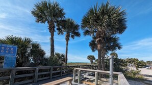 A wooden boardwalk with benches, palm trees, and a sign with park rules. - RV/camper in terrific Via Madonna property (Englewood)