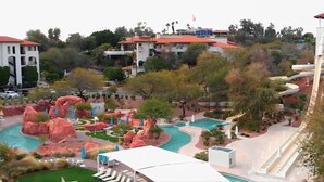 A resort with a swimming pool, red rock landscaping, and multiple buildings in the background. - *Sept Special* Pool~ASU~Long Stays~Sundevil Stay (Tempe)