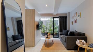 Premium Apartment, Patio | Living area | 50-inch flat-screen TV with digital channels