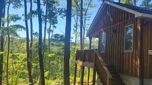 A wooden cabin with a wooden deck and stairs leading to a window. - Boho Getaway for Two, Stay near the New River Gorge and Glade Creek Farm (Cool Ridge)