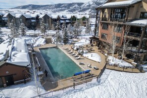 Outdoor pool, a heated pool - Moonlight Pooldeck - Trailhead’s Premier Resort Condo w Gondola Access (Steamboat Springs)
