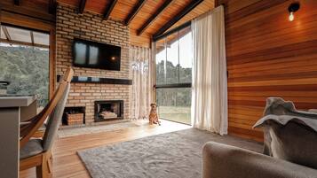 Deluxe Cabin, Jetted Tub, Lakeside | Living room | Fireplace