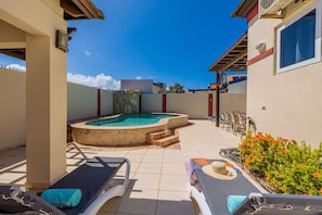 A pool area with lounge chairs, a hot tub, and a patio with outdoor furniture. - Sleeps 11 6 Bedrooms Privatepool Outdoor Dining (Noord)