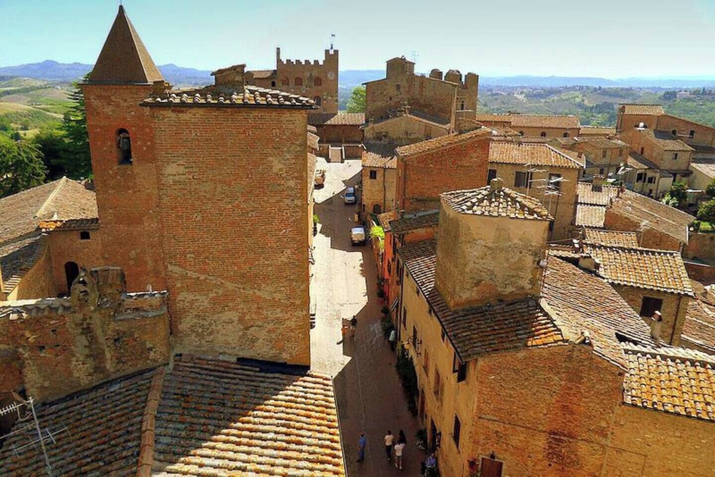 A historic town with medieval architecture, including a prominent tower and fortified walls.