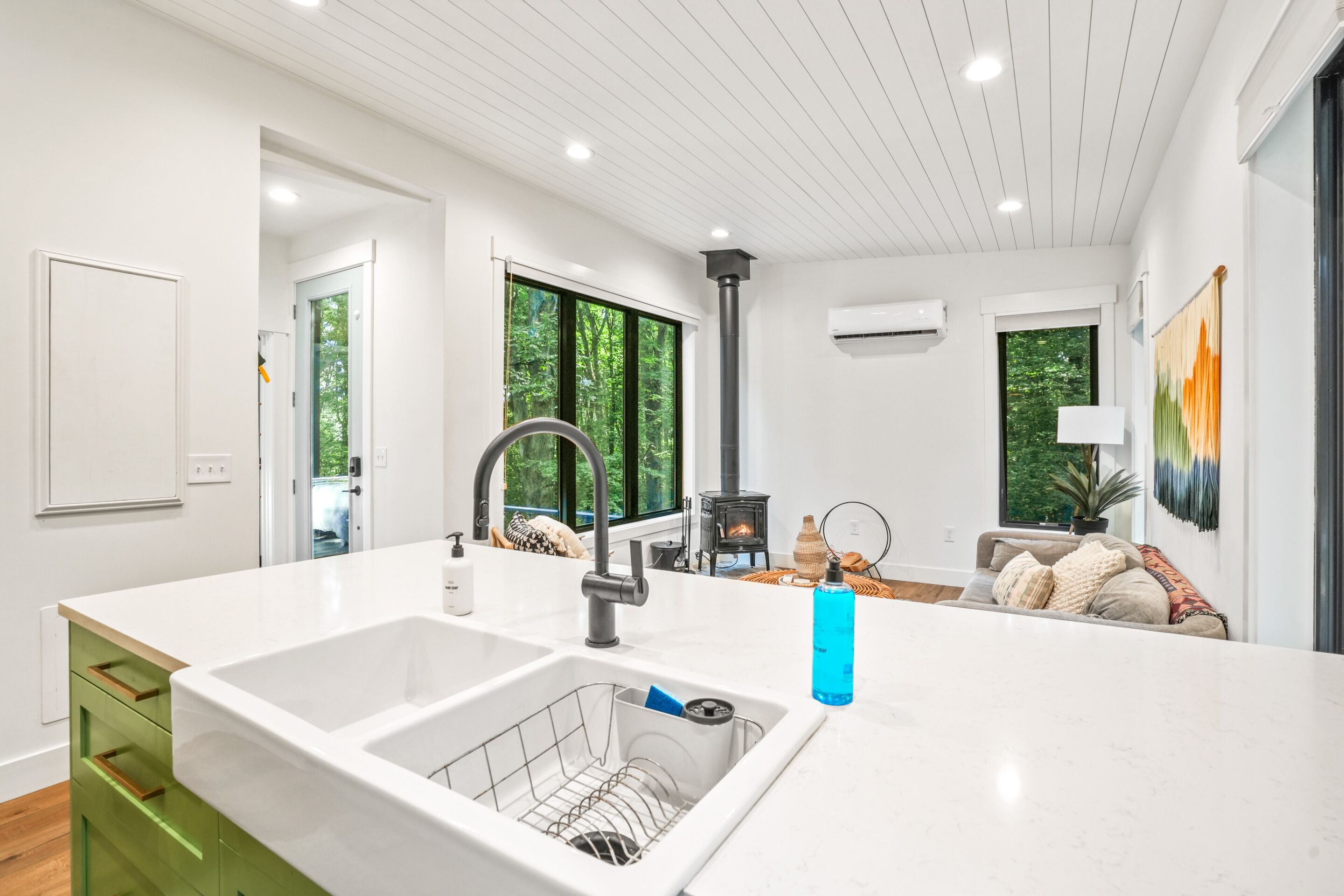 A modern kitchen with a large island, a built-in sink, and a stove.