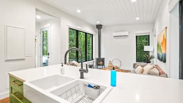 A modern kitchen with a large island, a built-in sink, and a stove.