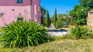 A pink building with a window and a lamp post, surrounded by greenery and trees. - Apartment Cotto by Interhome (Castiglioncello)